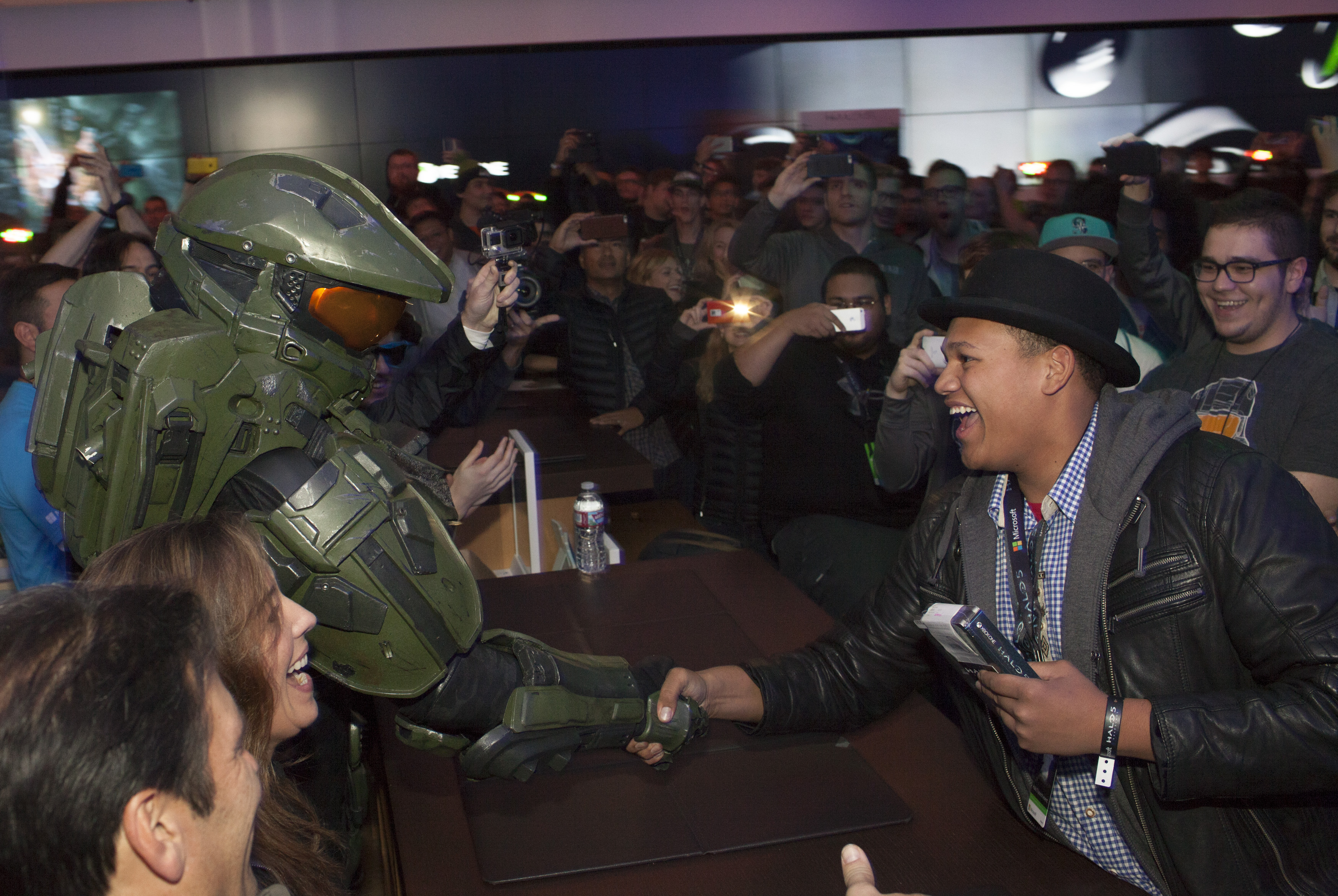 Head of Xbox Phil Spencer, Head of 343 Industries Bonnie Ross and the Master Chief deliver the first copy of “Halo 5: Guardians” at the Microsoft store in University Village in Seattle on Monday, Oct. 26, 2015 (Photo by Stephen Brashear/Invision for Microsoft/AP Images)